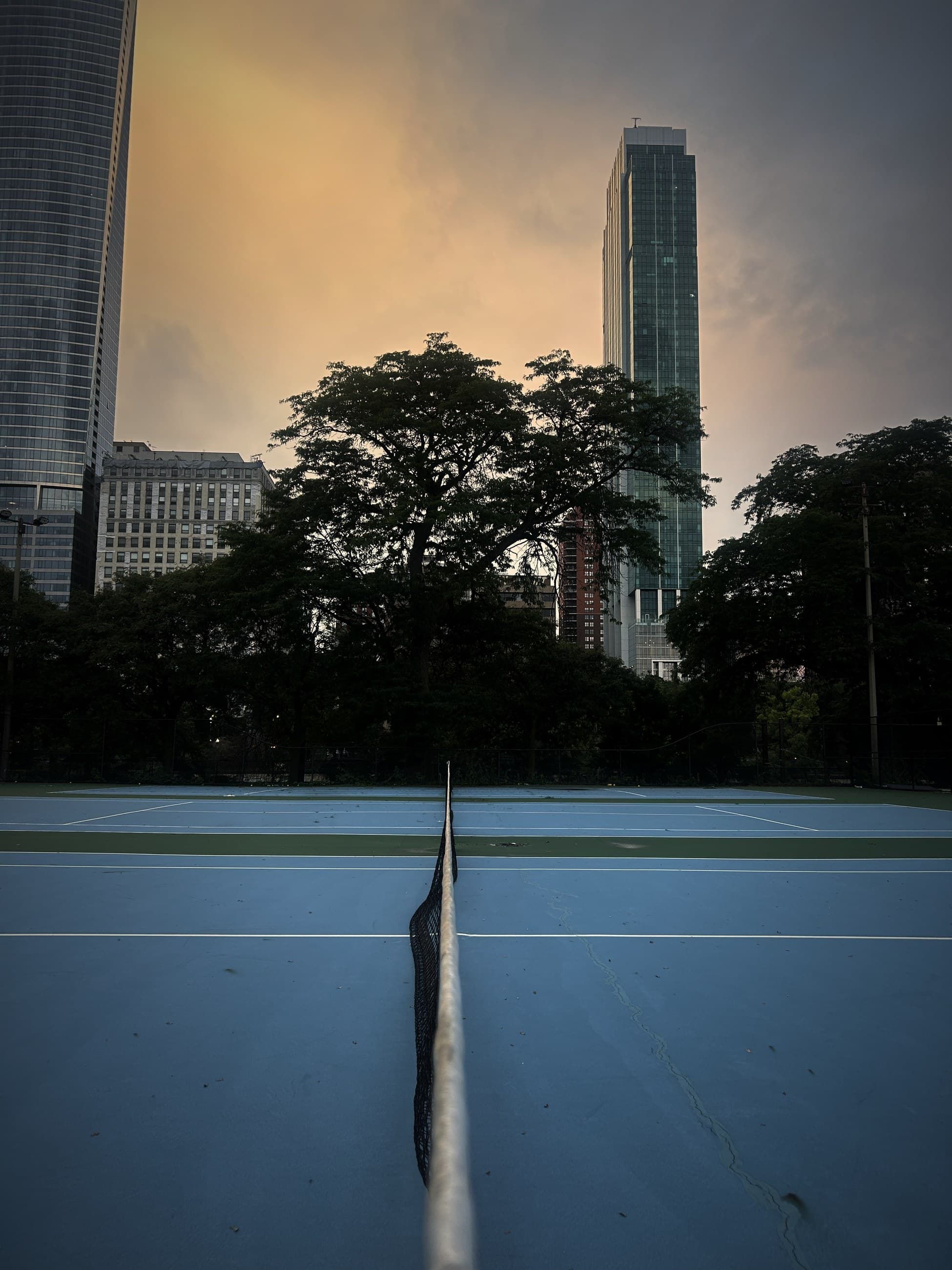 Tennis courts at dusk, Chicago skyline behind
